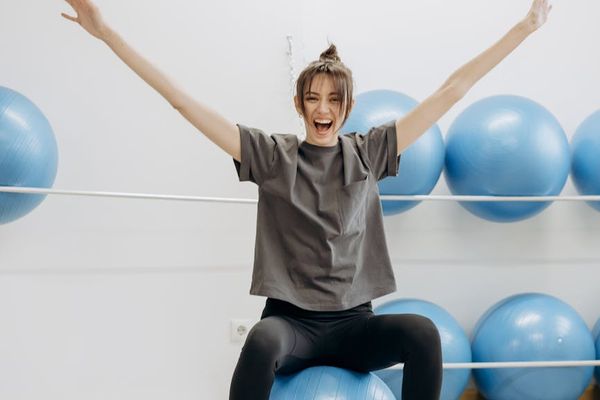 Person doing a light stretching exercise in a bright living room.