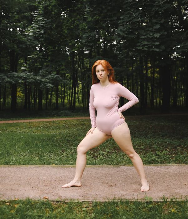 Woman in a calm, balanced pose, embodying mindful movement.